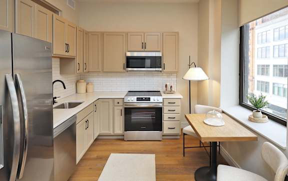 A modern kitchen with wooden cabinets and stainless steel appliances.