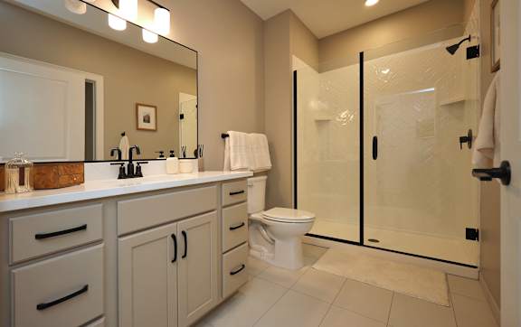 A bathroom with a toilet, sink, and shower.