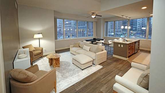 A living room with a brown couch and a white couch.