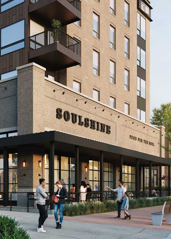 A group of people are walking outside of a building with a sign that says "Soulshine".
