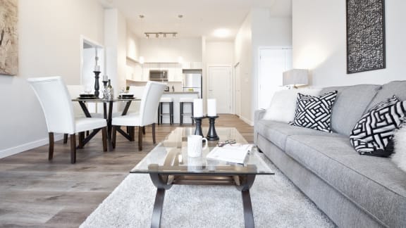 a living room and dining room with a couch and a table