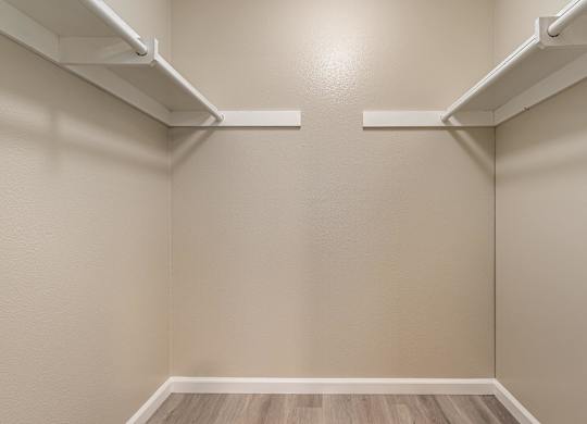 an empty room with white shelves on the wall and wood floors at Colima Terrace Apts, Rowland Heights, CA 91748