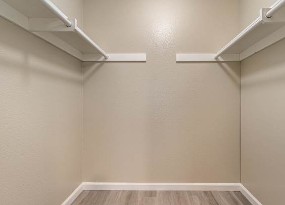 an empty room with white shelves on the wall and wood floors at Colima Terrace Apts, Rowland Heights, CA 91748