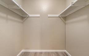 an empty room with white shelves on the wall and wood floors at Colima Terrace Apts, Rowland Heights, CA 91748