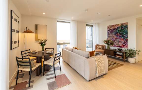  Open-plan living and dining room with stylish furnishings and balcony access.