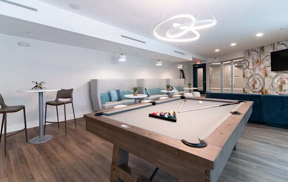 Luxurious lounge at NOVI with pool table, booths and tables.