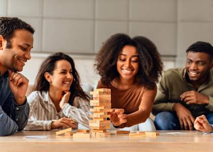 A group of people are playing a game of Jenga.