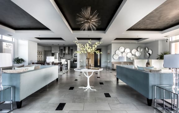 a living room with couches and a table at The Heights at Park Lane, Dallas, TX, 75231