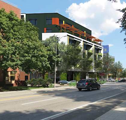 a large building on the side of a street with cars driving at 605 Concord at Fresh Pond Apartments, Cambridge, MA, 02138