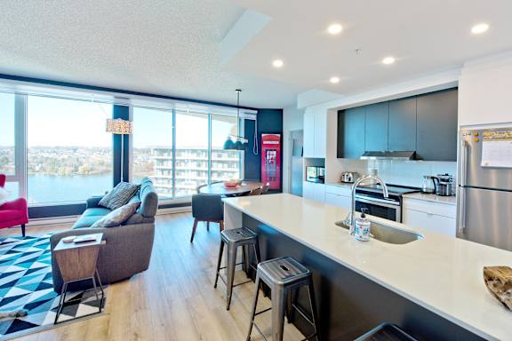 A modern kitchen with a view of the city.