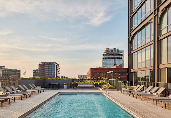 this is a photo of a swimming pool on the roof of a building in the city