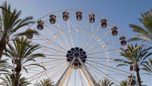 A Ferris wheel with a blue sky in the background.