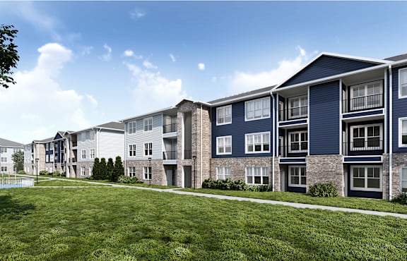 A row of modern apartment buildings with green lawns in front.