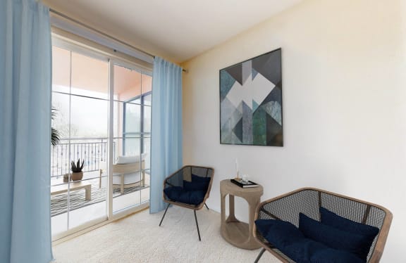 a living room with a balcony and a chair and a table at Marina Harbor, Marina del Rey, CA