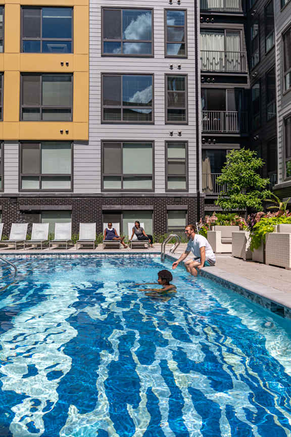 a swimming pool in the middle of two apartment buildings