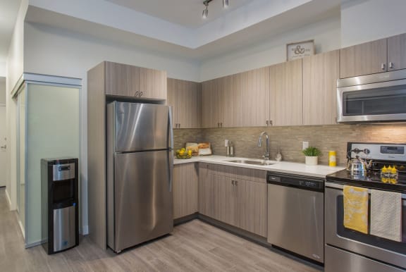 a kitchen with stainless steel appliances and wooden cabinets