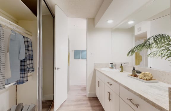 a dining room with a table and chairs and a kitchen  at Mediterranean Village West Hollywood, West Hollywood