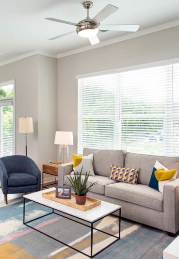 a living room with a couch and a table at One Riverside Apartments, Chattanooga, TN, 37403