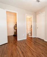 a renovated living room with hard wood flooring and a bathroom
