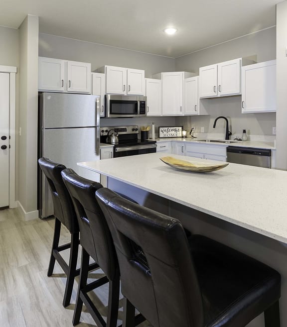 a kitchen with white cabinets and a white counter top