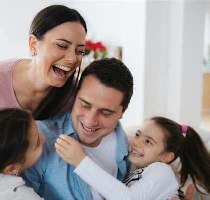 a mother and father laughing with their two daughters at Casa De Miranda, San Diego, CA 92713