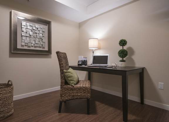 a home office with a laptop computer on a desk
