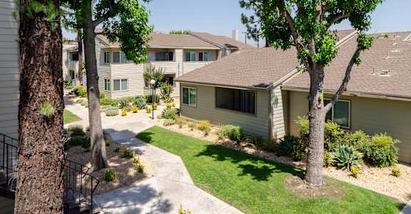 a group of houses with trees and a sidewalk at Aspire Rialto, Rialto, California, 92376