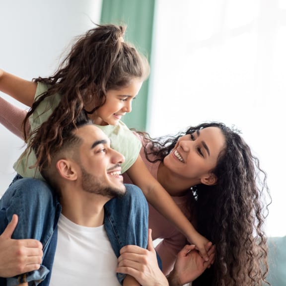 family smiling in bright living room