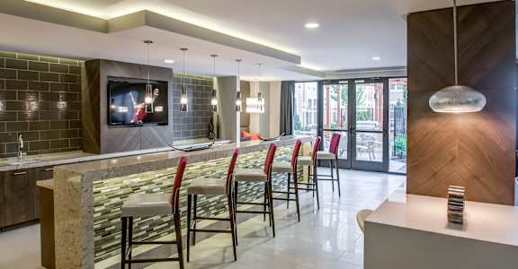 A modern bar area with a television on the wall.