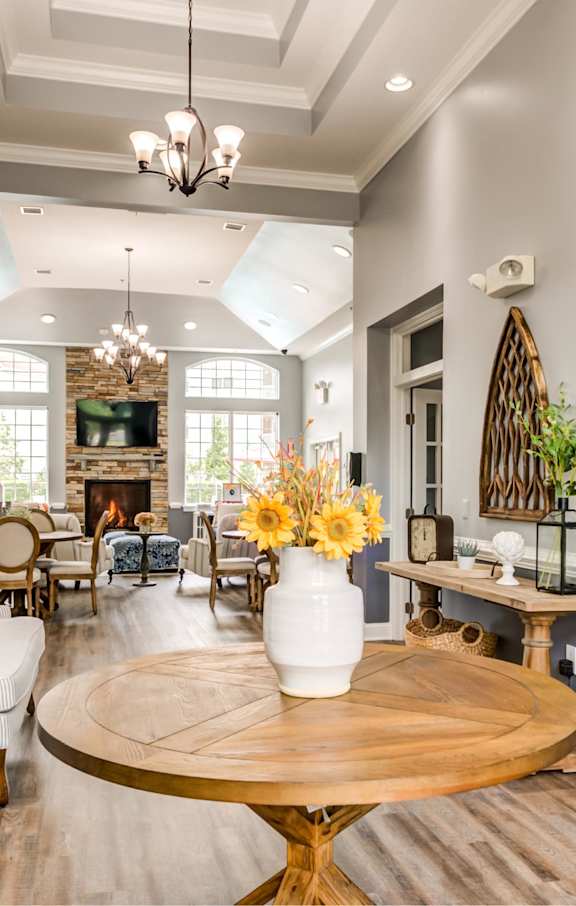 A living room with a fireplace and a dining table.