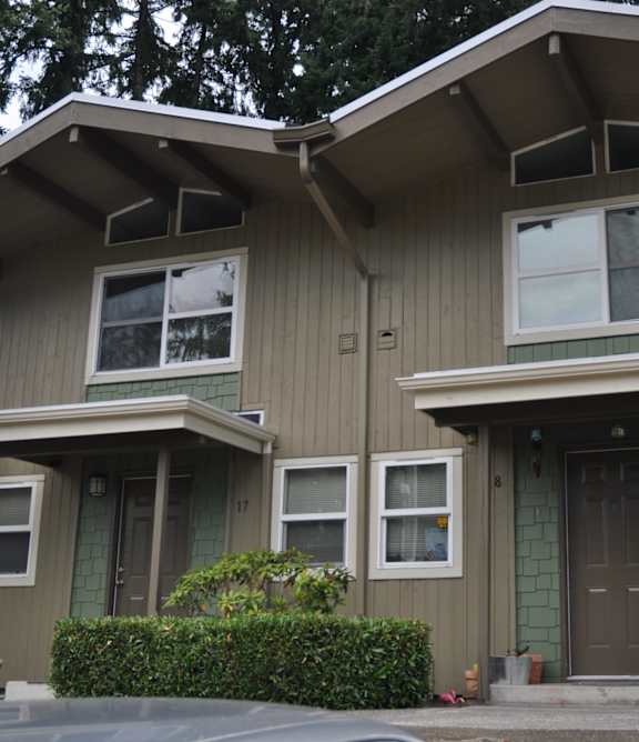 A house with a grey exterior and a brown door.