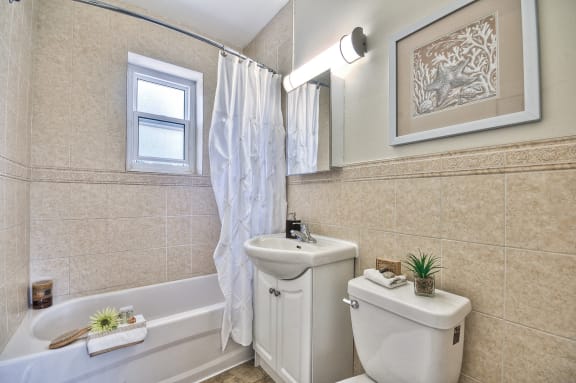 a bathroom with a sink toilet and a bath tub