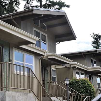 A house with a green door and a brown railing.