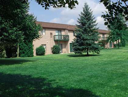 our apartments are located in a quiet neighborhood with green grass and trees