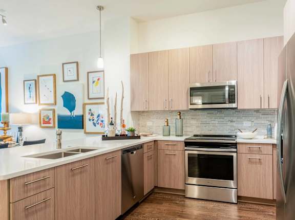 A kitchen with wooden cabinets and stainless steel appliances.