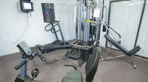 a gym with a lot of equipment in a room