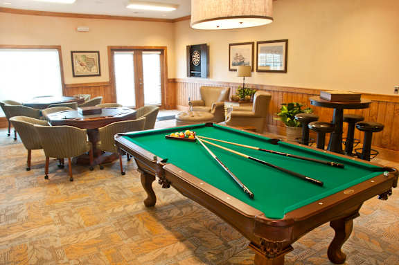 a games room with a pool table and chairs at Mariposa at Bay Colony, Dickinson