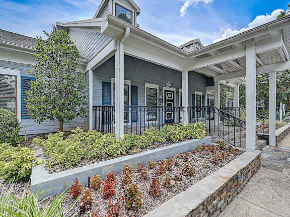 A house with a grey front and a white porch.