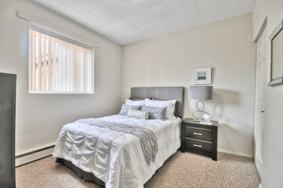 a bedroom with a bed and a window