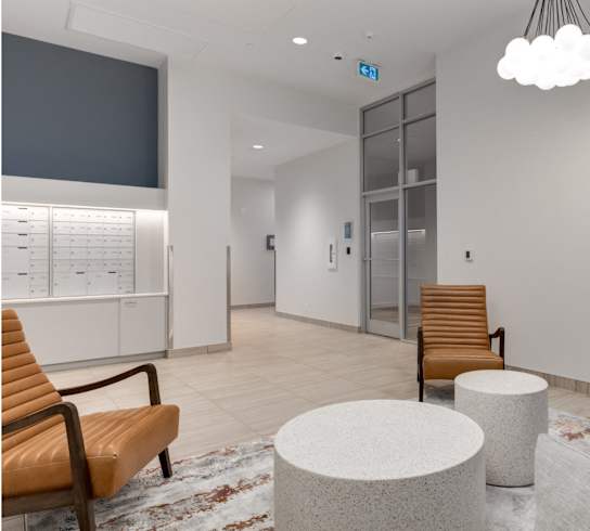 A waiting area with a chair, a table, and a TV.