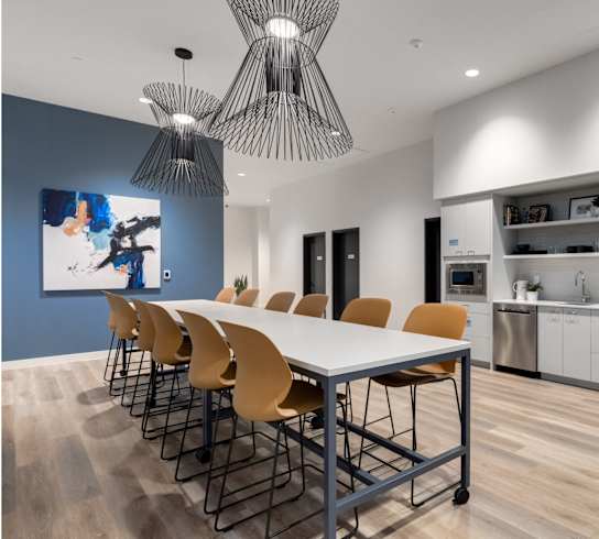 A modern kitchen with a dining table and chairs.