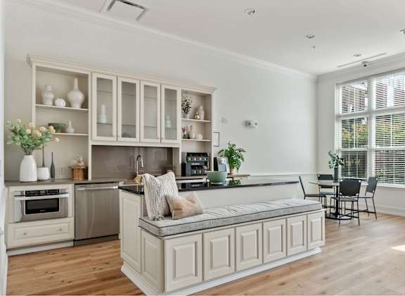 A kitchen with a large island and a dining area.