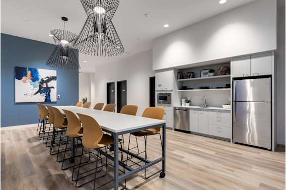 A modern kitchen with a dining table and chairs.