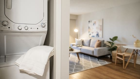 a view of a living room with a washing machine and a couch