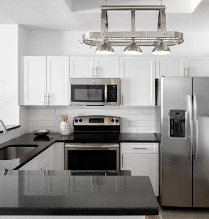 a kitchen with stainless steel appliances and white cabinets