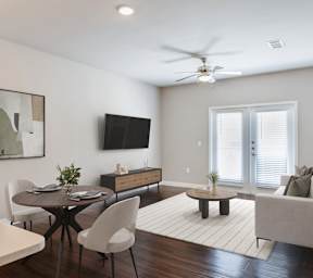 A modern living room with a dining table and chairs.
