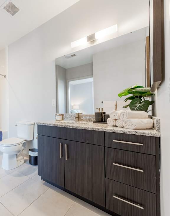 a bathroom with a white toilet next to a bathtub with a shower curtain at Heights at Glen Mills, Glen Mills, PA 19342
