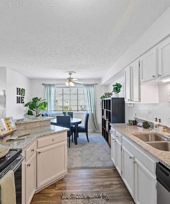 A kitchen with white cabinets and a black stove top.