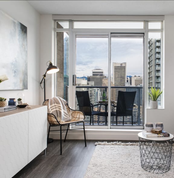 a living room with a view of a city skyline and a blue couch and chair