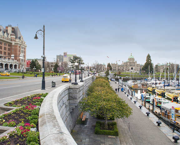 a view of a city street with buildings and a harbor